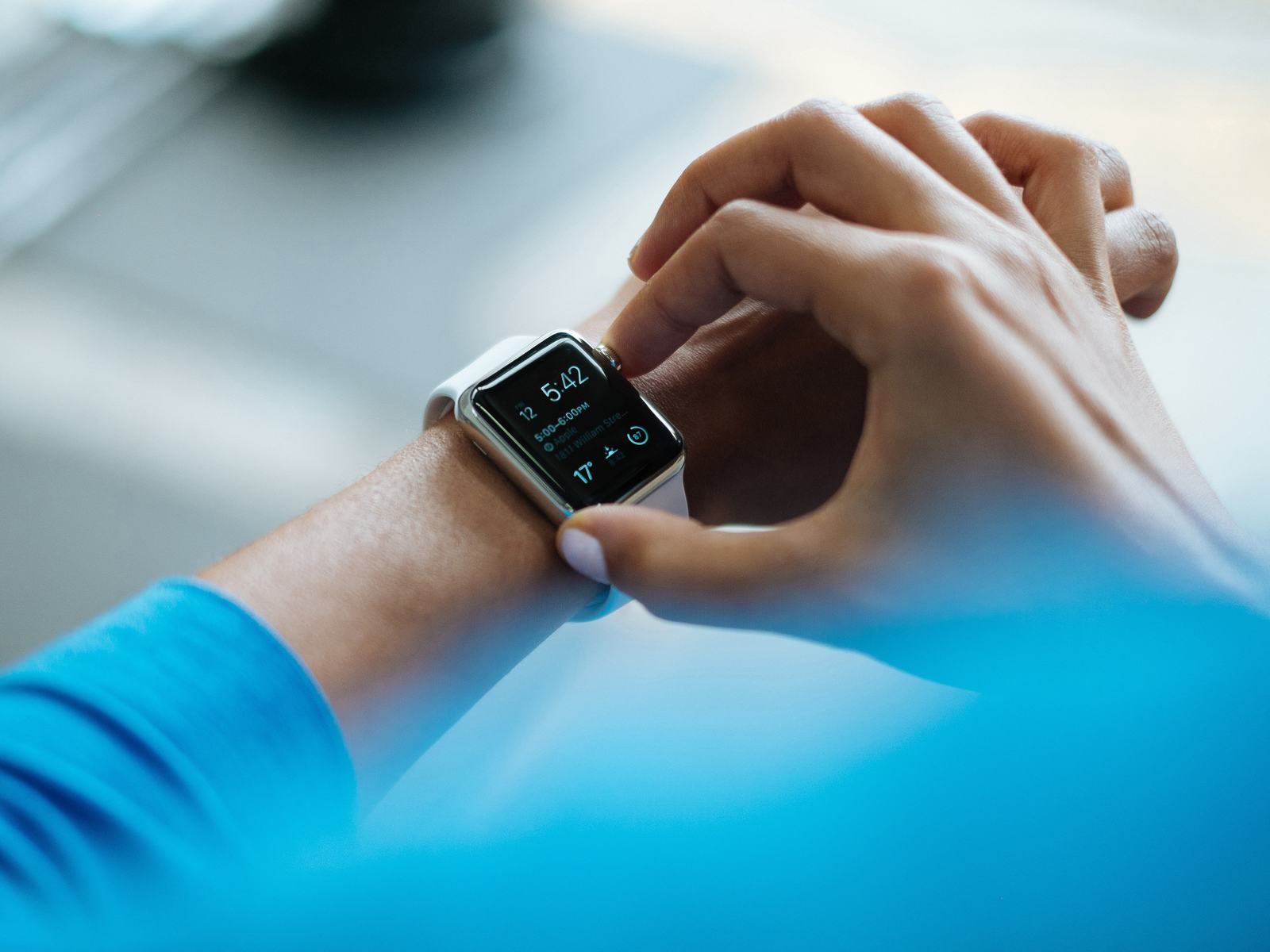 A person checking a smartwatch on their wrist