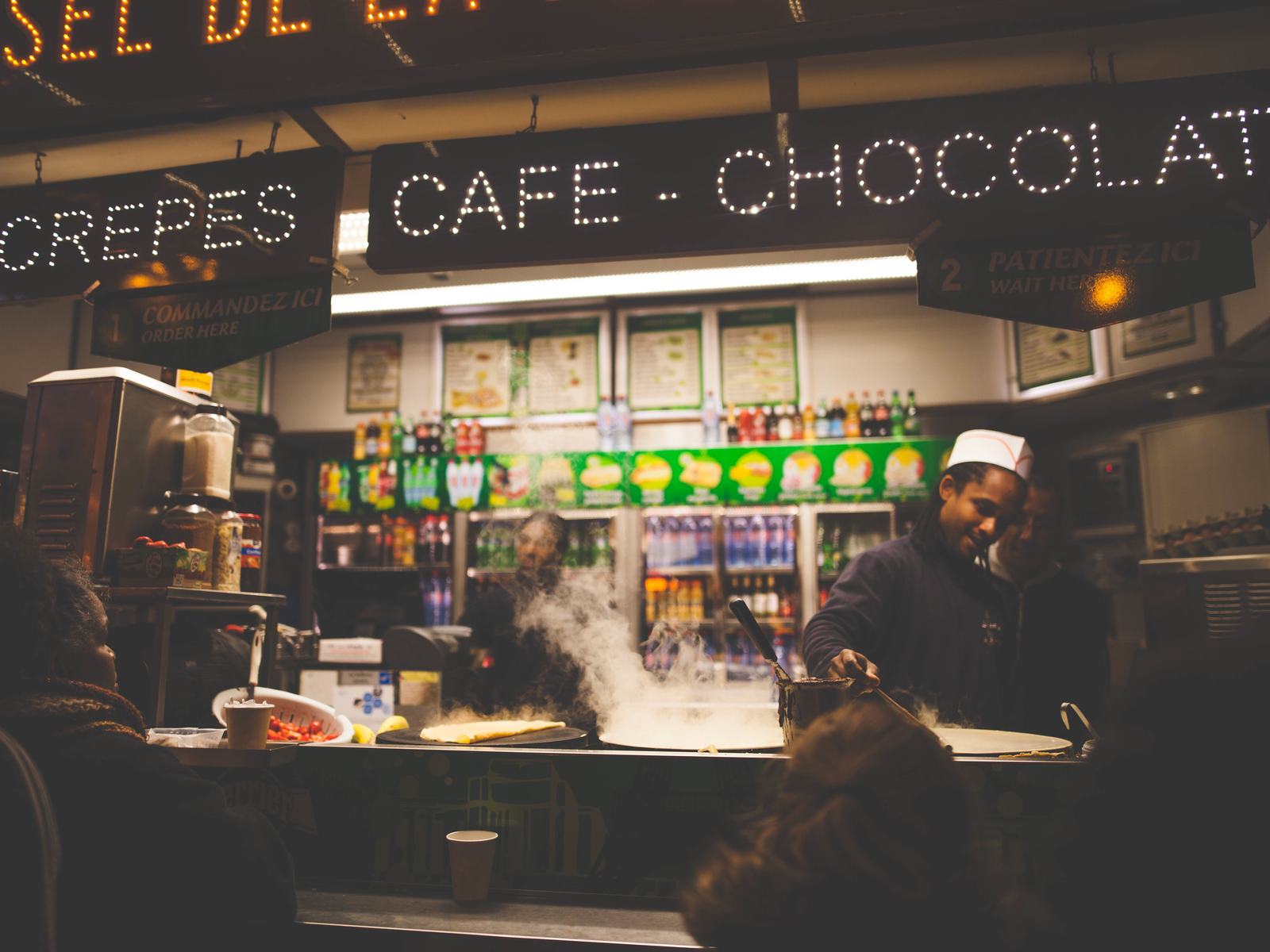 A busy café counter in the evening