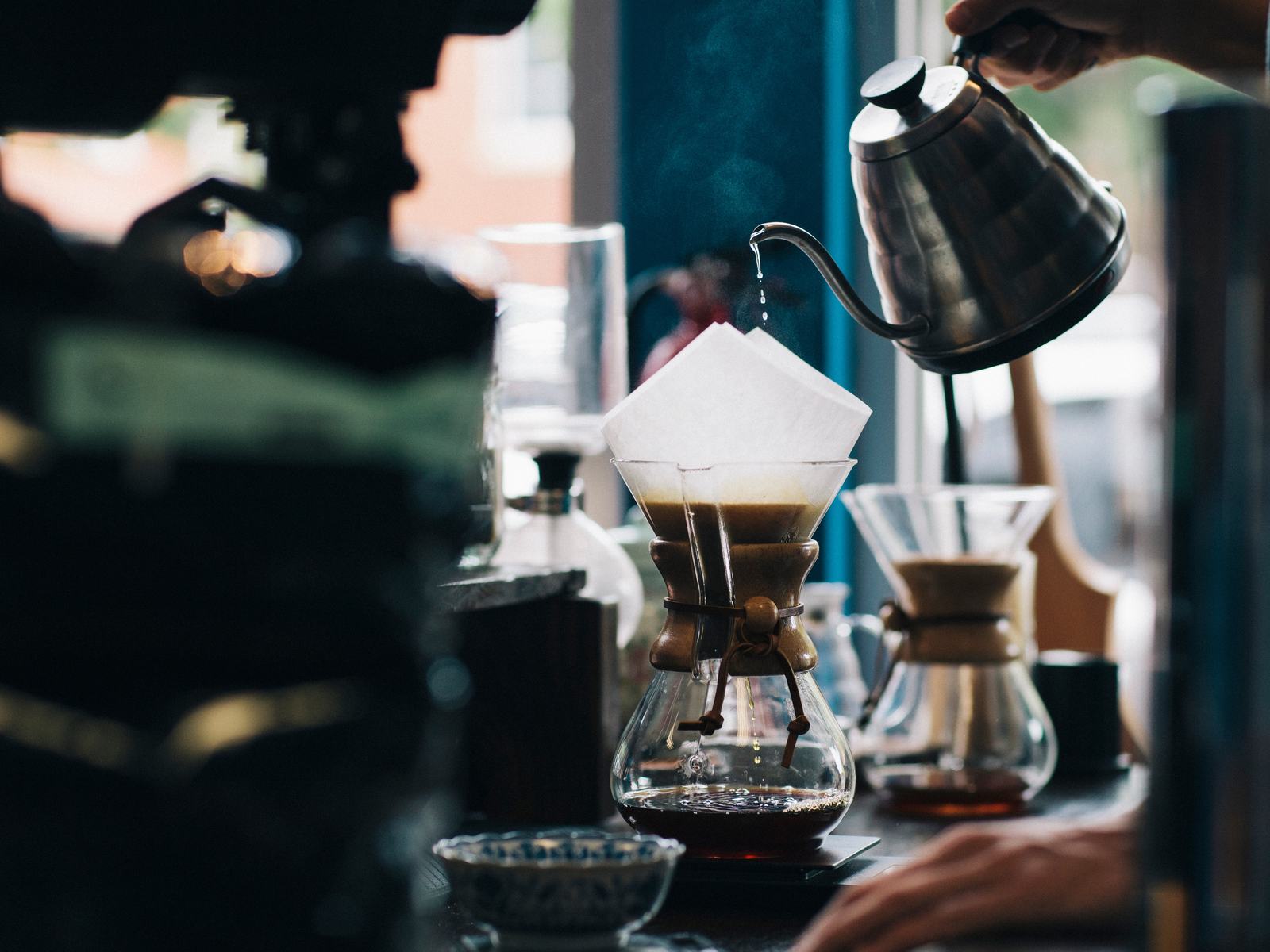 Coffee being poured over at a café bar