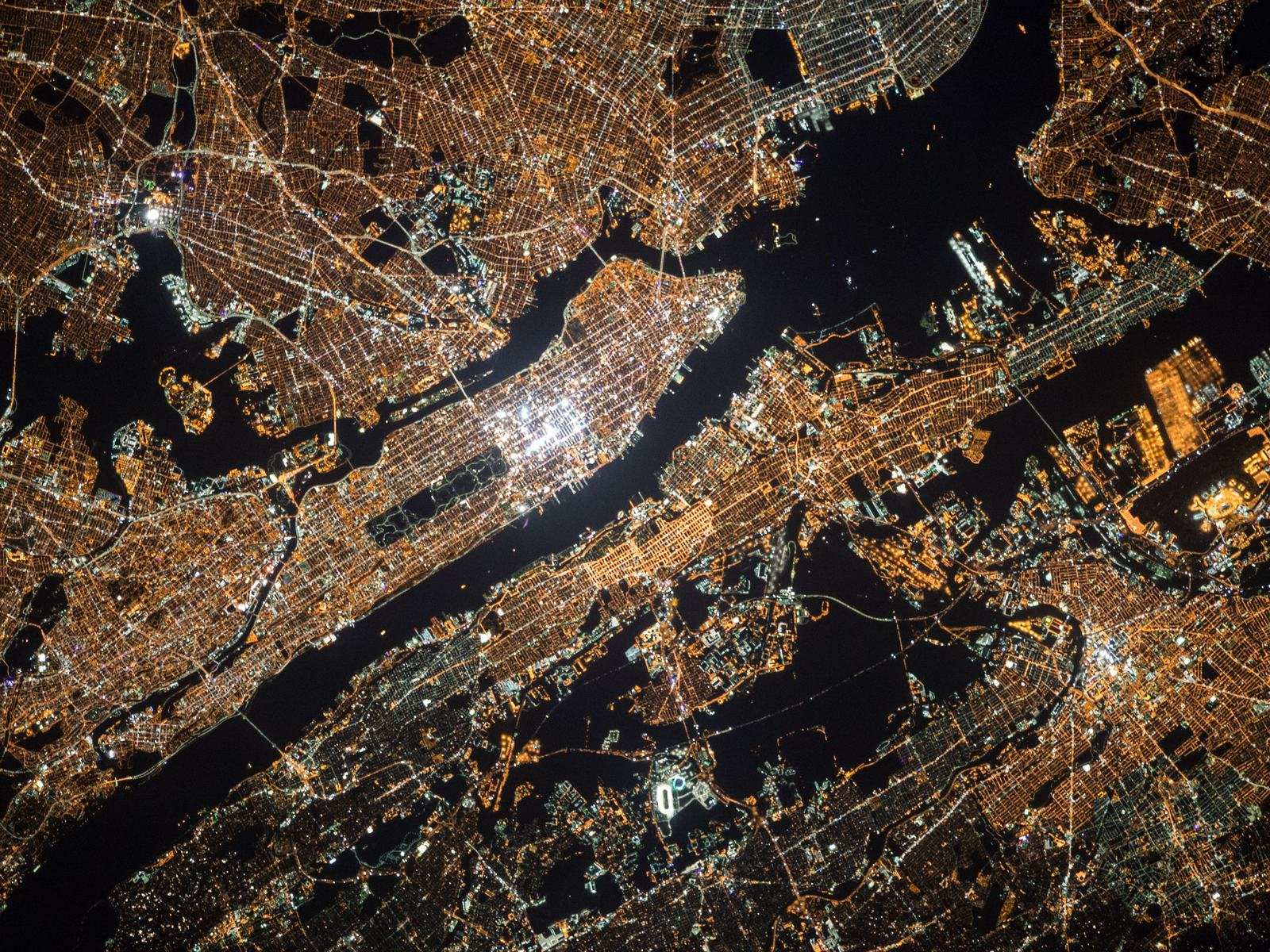 A city grid lit up at night, seen from above